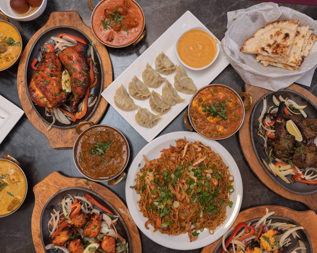 Yak and Yeti Himalayan Cuisine signature dishes Chicken Tikka MasalaLamb Momo (Dumplings)Garlic NaanSaag Paneer